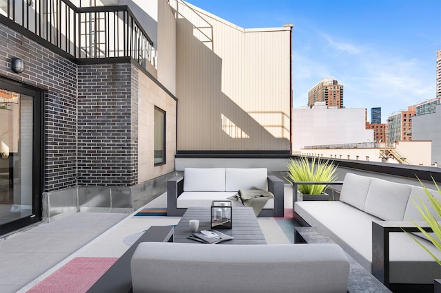 view of patio featuring outdoor lounge area, a balcony, and a city view