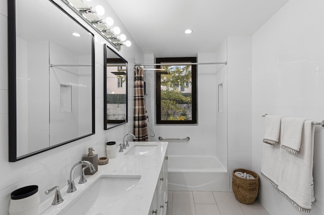 bathroom featuring tile patterned flooring, double vanity, recessed lighting, and a sink