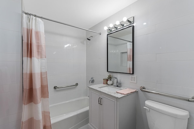 full bathroom with vanity, tile walls, toilet, and shower / bathtub combination with curtain