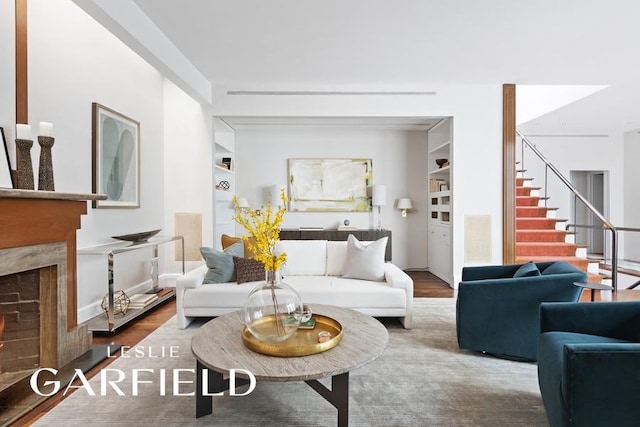 living room featuring a premium fireplace and hardwood / wood-style floors