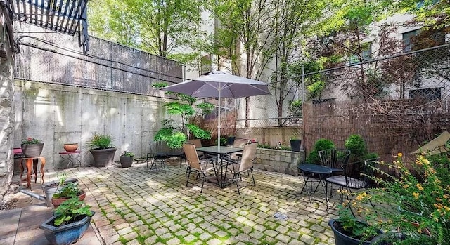 view of patio with fence and outdoor dining space