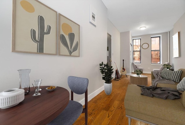 dining space with wood-type flooring