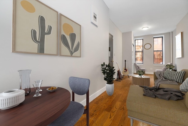 office space with wood finished floors, visible vents, and baseboards