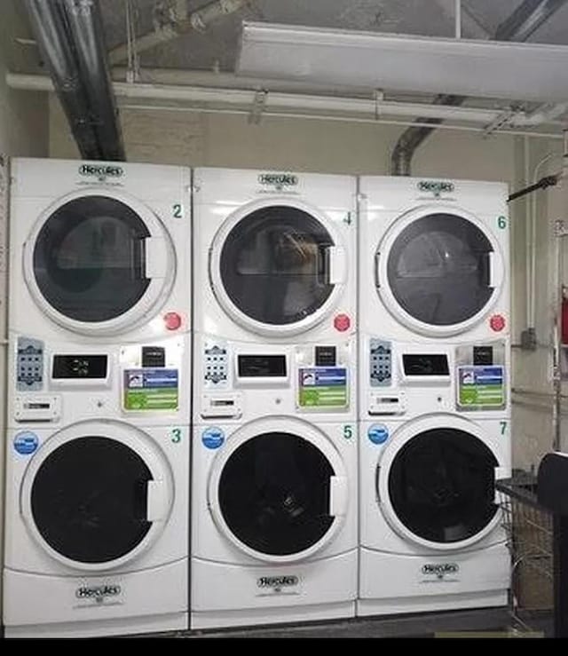 shared laundry area featuring stacked washer / dryer and washing machine and clothes dryer