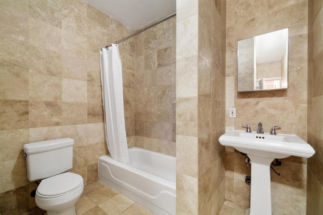 bathroom featuring shower / bath combo, tile walls, tile patterned floors, and toilet