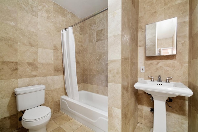 bathroom featuring shower / bath combo, tile patterned flooring, tile walls, and toilet