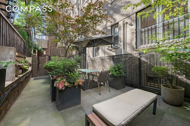 view of patio / terrace featuring fence