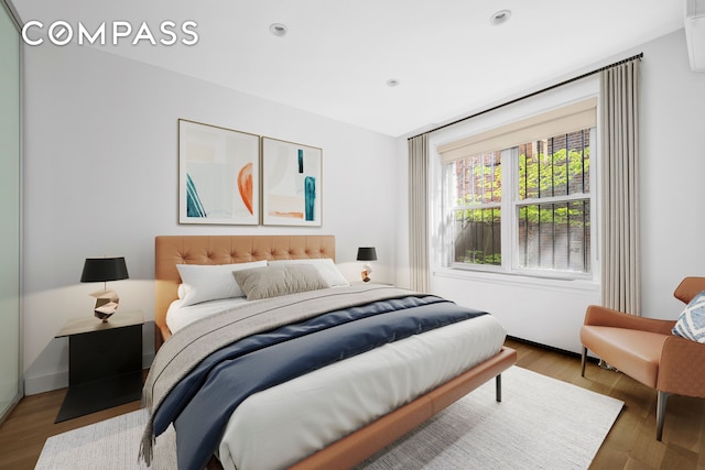 bedroom featuring recessed lighting and wood finished floors