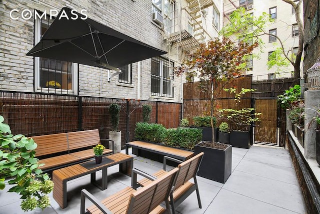 view of patio / terrace featuring an outdoor hangout area and fence