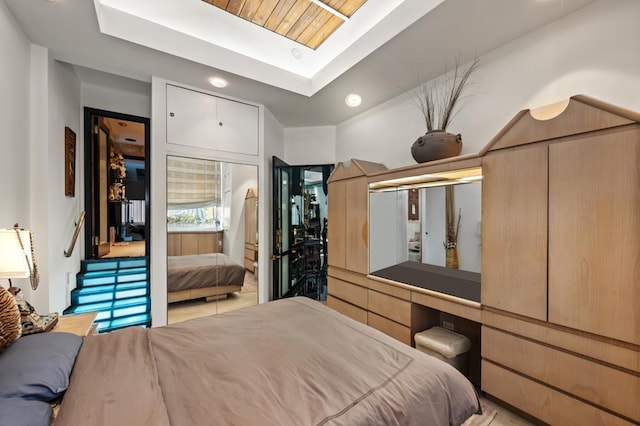 bedroom featuring a skylight and a tray ceiling