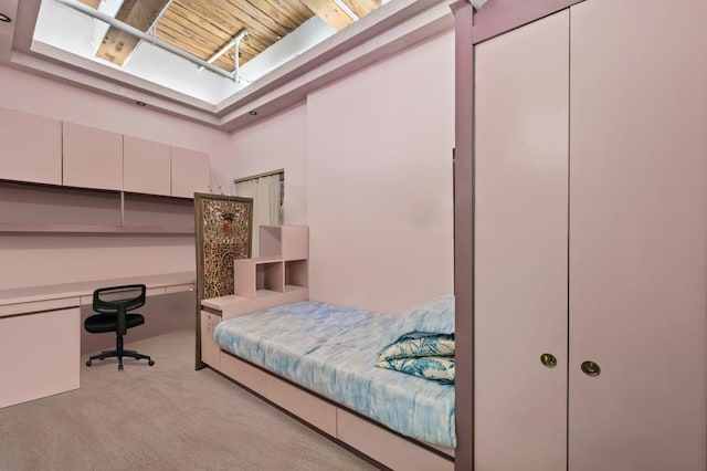 carpeted bedroom with wood ceiling