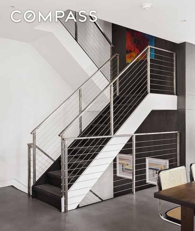 staircase featuring concrete flooring