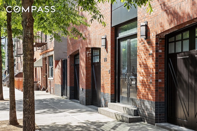 property entrance with brick siding