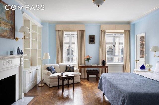 bedroom featuring crown molding and a fireplace with flush hearth