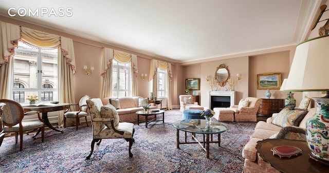 living area featuring baseboards and a fireplace