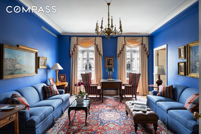 living room with a notable chandelier and ornamental molding