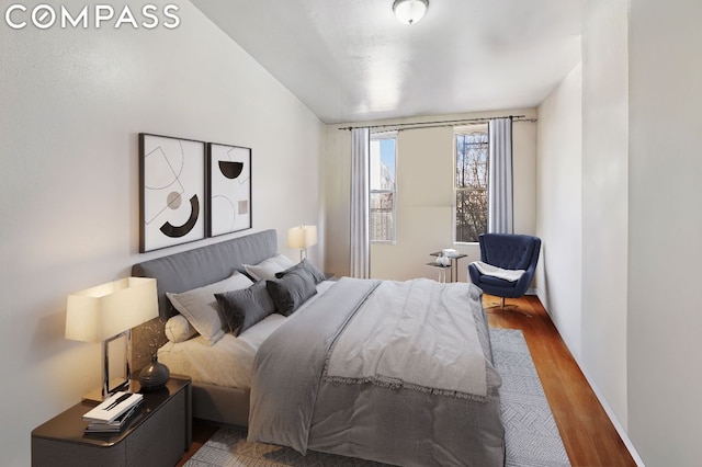 bedroom featuring hardwood / wood-style flooring and vaulted ceiling