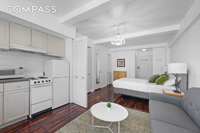 bedroom featuring a notable chandelier, beam ceiling, dark wood-type flooring, and freestanding refrigerator