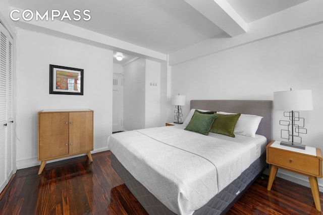 bedroom featuring baseboards and wood finished floors