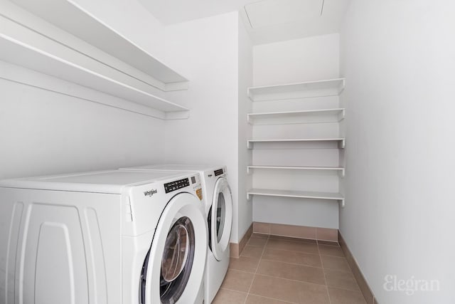 laundry room featuring laundry area, baseboards, light tile patterned flooring, and independent washer and dryer