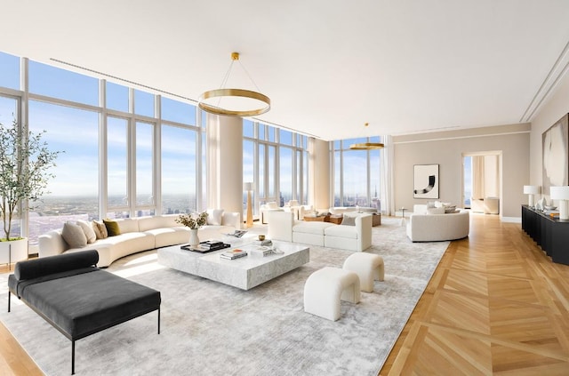 living room featuring parquet floors, a wall of windows, and a healthy amount of sunlight