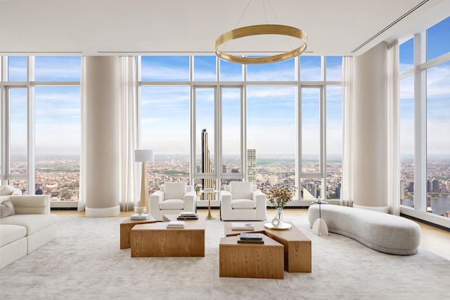 living area featuring floor to ceiling windows, wood finished floors, and a city view