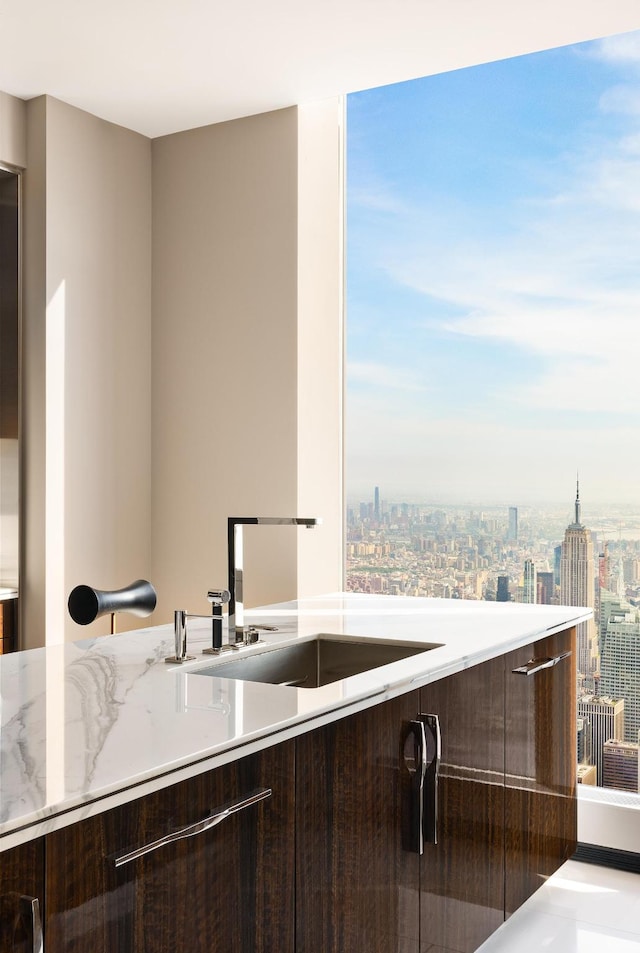 kitchen with a city view, a sink, and modern cabinets