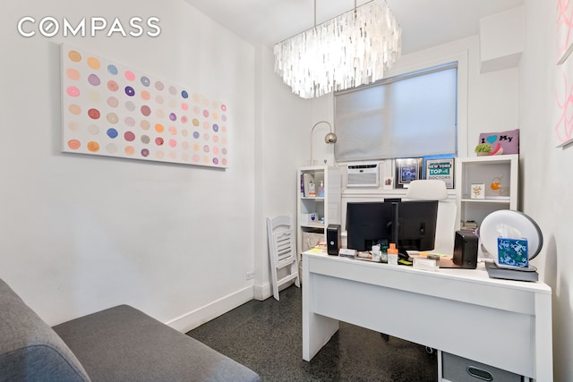 home office featuring baseboards, a notable chandelier, and dark speckled floor