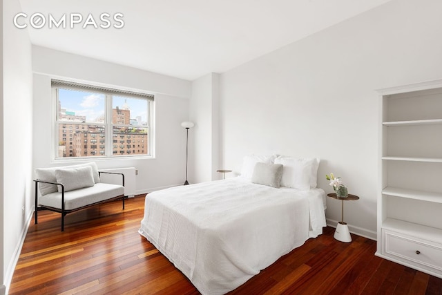 bedroom featuring dark hardwood / wood-style flooring