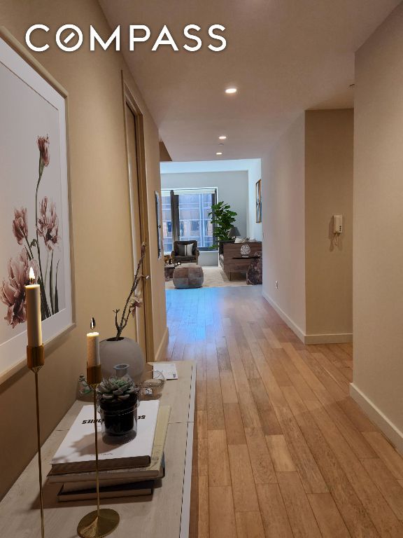 corridor with light hardwood / wood-style floors