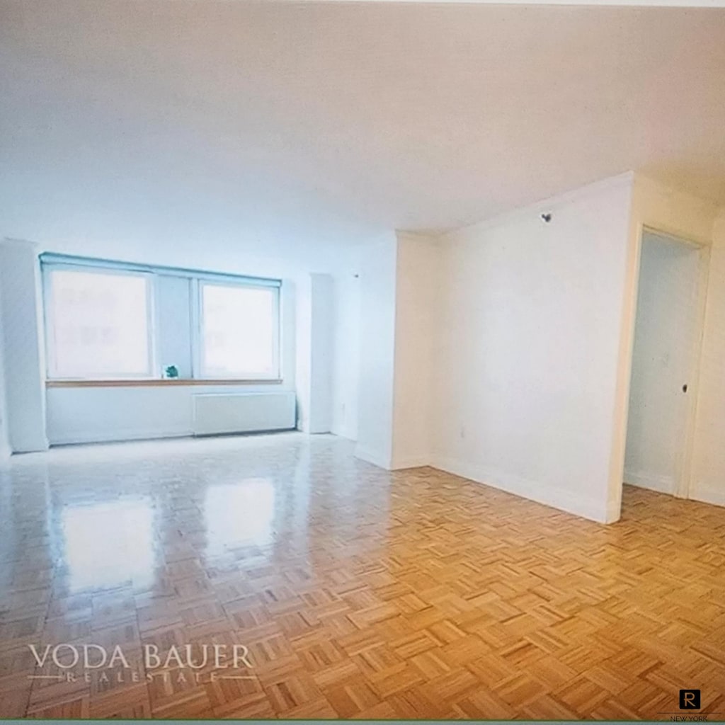 spare room featuring baseboards