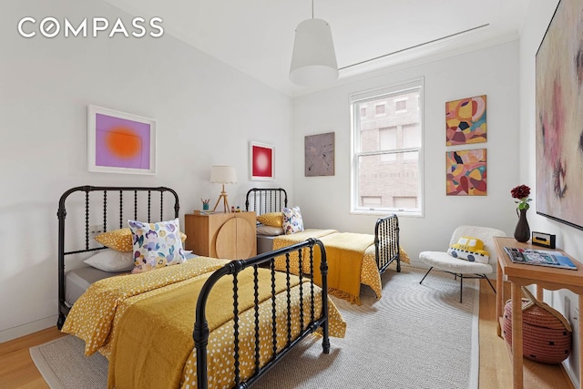 bedroom with light wood-style flooring and baseboards