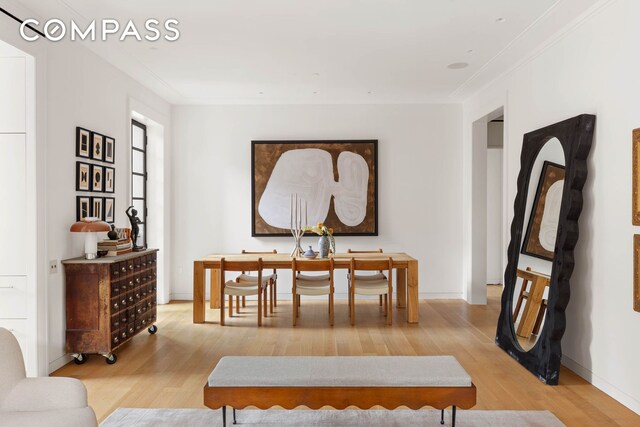 interior space featuring wood-type flooring and ornamental molding