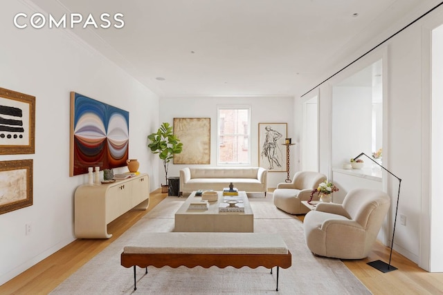 living room featuring baseboards and light wood-style floors