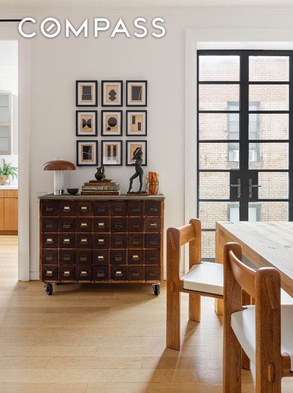 living area with light wood-style floors and french doors