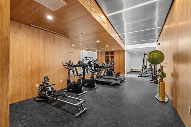 workout area with wooden ceiling, wooden walls, and recessed lighting