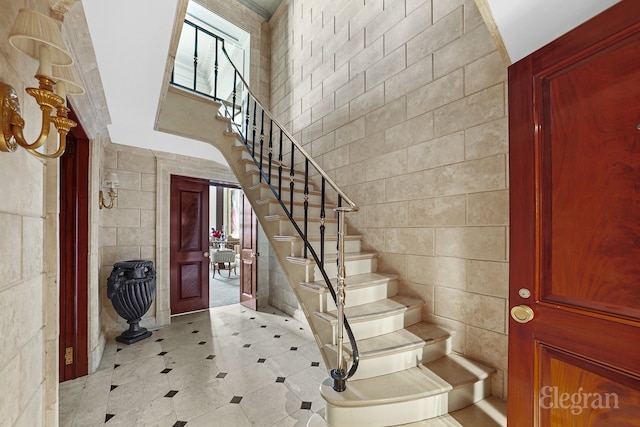 322 E 57th St Unit 12/13B, New York City, NY 10022 - foyer with tile walls and stairs