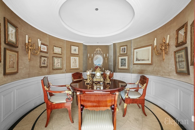 322 E 57th St Unit 12/13B, New York City, NY 10022 - dining room with tile patterned flooring, a decorative wall, ornamental molding, and wainscoting