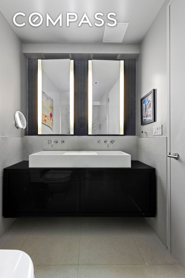 bathroom featuring double vanity and a sink