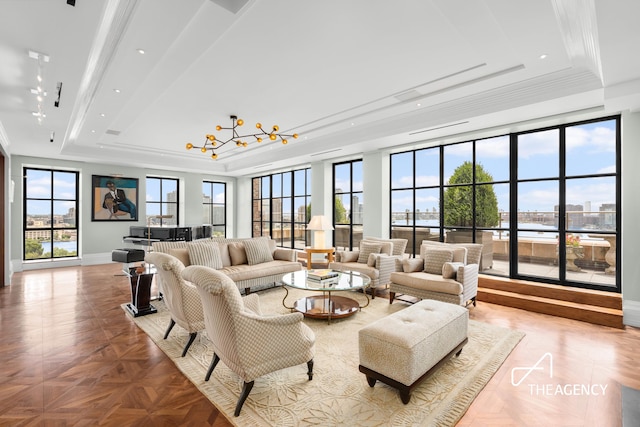 interior space featuring a raised ceiling and a notable chandelier