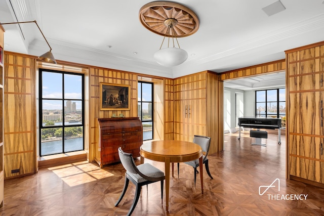 dining room featuring plenty of natural light and crown molding