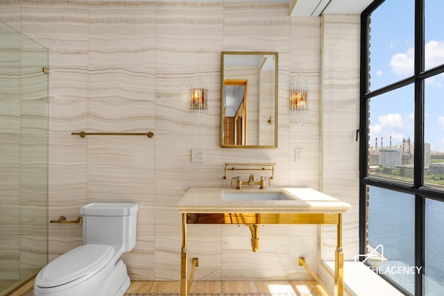 bathroom with toilet and tile walls