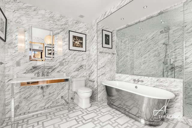 bathroom with a freestanding bath, vanity, a marble finish shower, and toilet