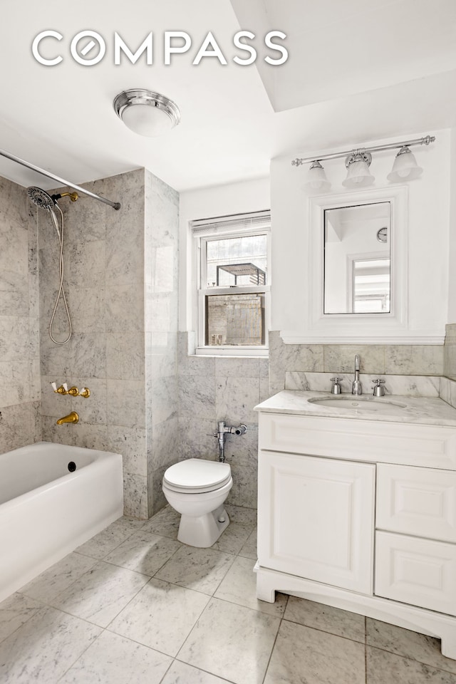 bathroom with tub / shower combination, toilet, tile walls, and vanity