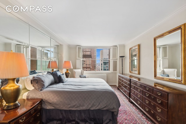 bedroom with ornamental molding and multiple windows