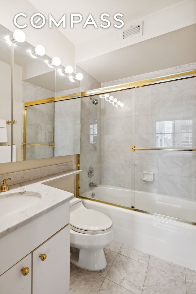 bathroom with visible vents, bath / shower combo with glass door, toilet, marble finish floor, and vanity