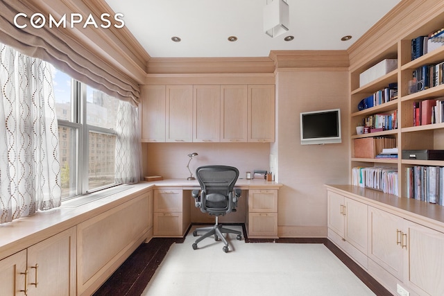 home office with ornamental molding and built in study area