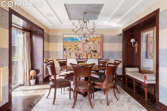 dining room with a chandelier and a tray ceiling