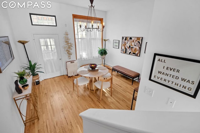 dining room featuring wood-type flooring and a notable chandelier