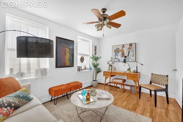 living room featuring ceiling fan and hardwood / wood-style floors